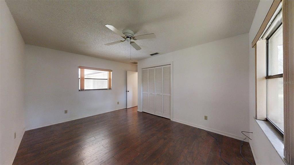 53 North Archwood Drive Inverness, FL 34450 - Photo 55 of 81 a view of empty room with wooden floor and fan