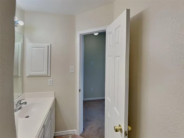 a bathroom with a tub sink and vanity