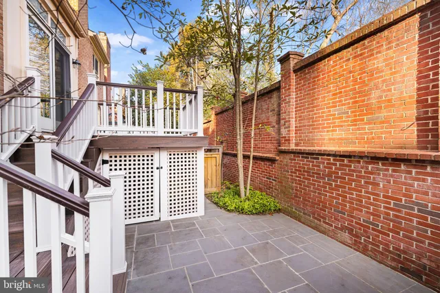 a view of a brick house with many windows
