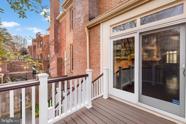 a view of a balcony with a door and wooden floor