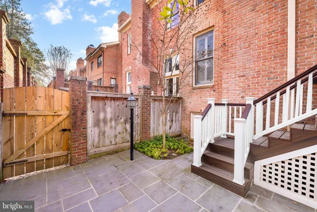 a view of a street with wooden fence