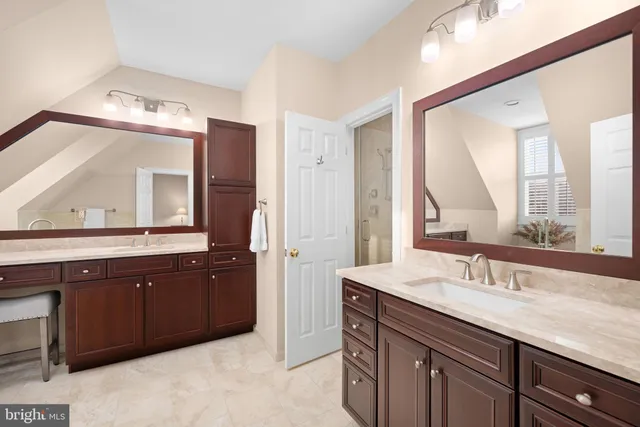 a bathroom with a double vanity sink and a mirror
