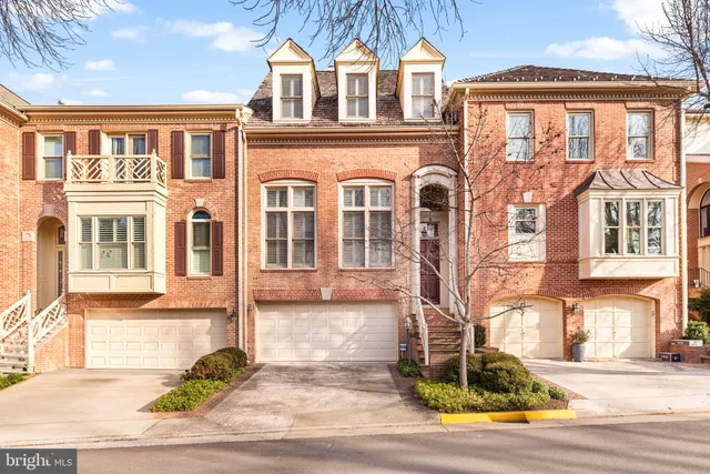 a front view of a residential houses with yard