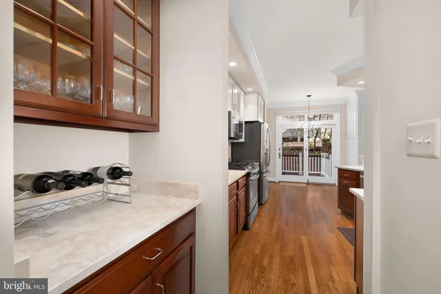 a kitchen with granite countertop a sink a stove and wooden cabinets