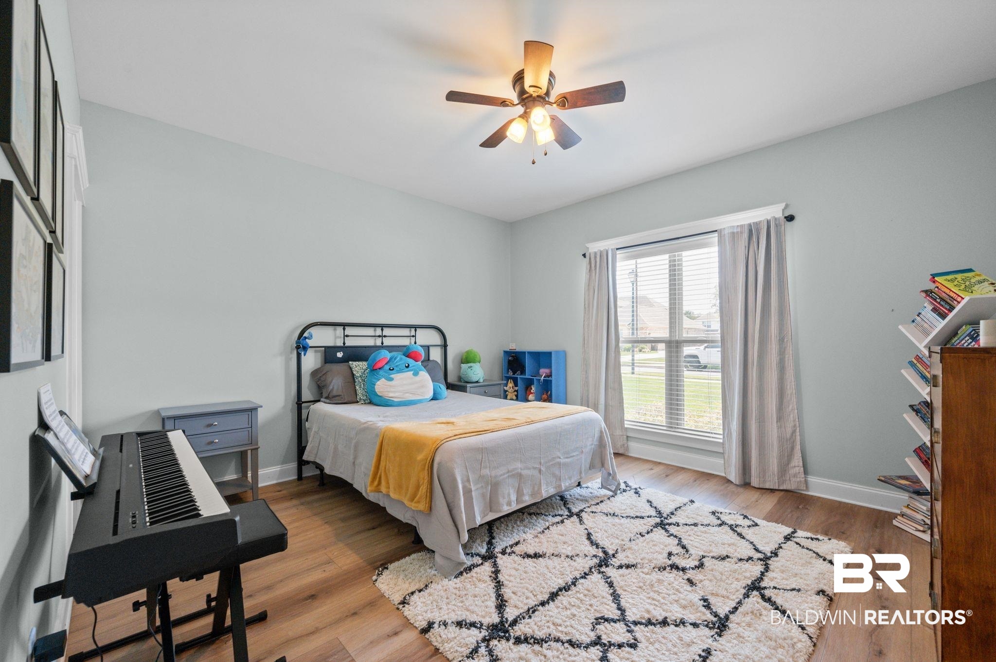 409 Fortune Drive Fairhope, AL 36532 - Photo 30 of 42 Bedroom featuring wood-finish flooring, a ceiling fan with integrated lighting, and a large window with blinds