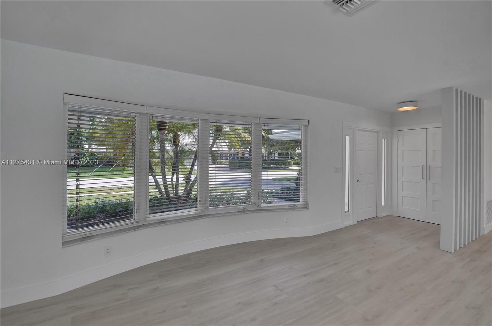1311 Mulberry Way Boca Raton, FL 33486 - Photo 15 of 45 a view of an empty room with a sliding door
