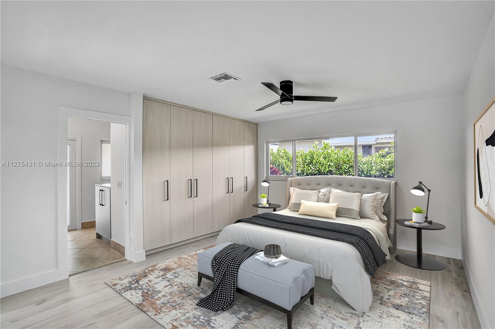1311 Mulberry Way Boca Raton, FL 33486 - Photo 17 of 45 a bedroom with a bed and a window