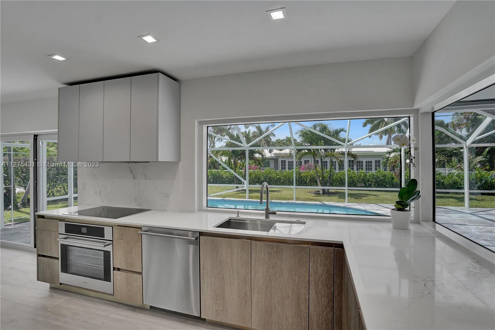 1311 Mulberry Way Boca Raton, FL 33486 - Photo 2 of 45 a open kitchen with granite countertop a sink and a stove