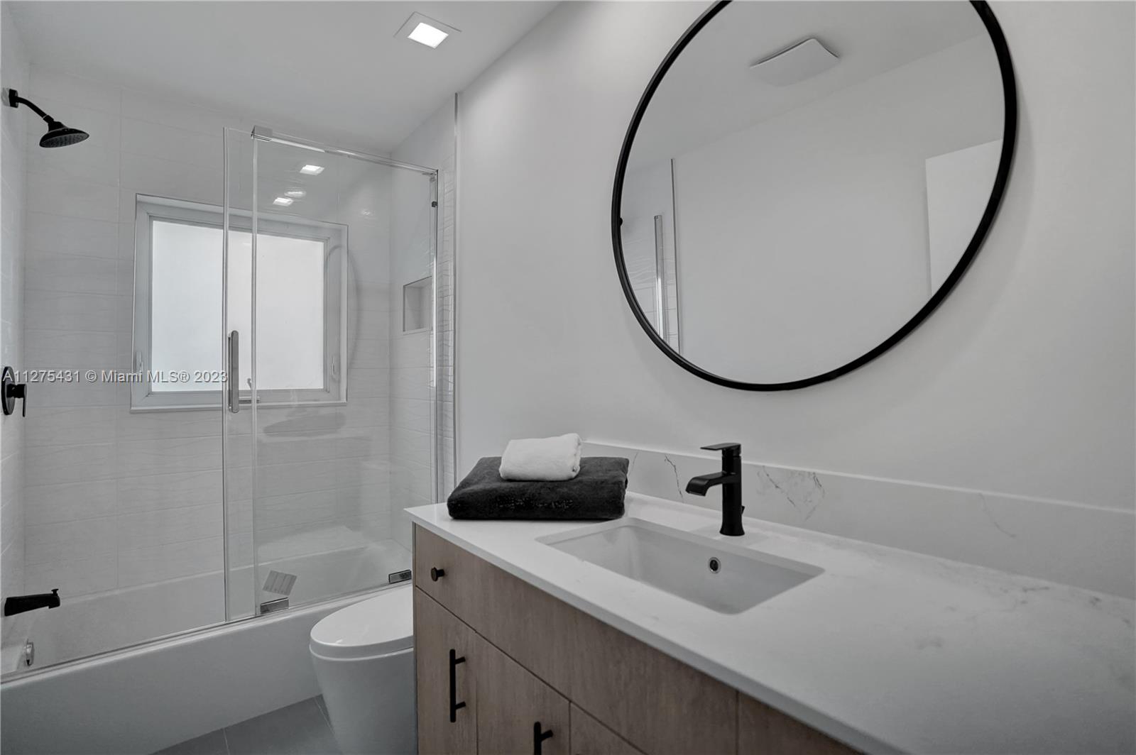 1311 Mulberry Way Boca Raton, FL 33486 - Photo 30 of 45 a bathroom with a sink a toilet and a mirror