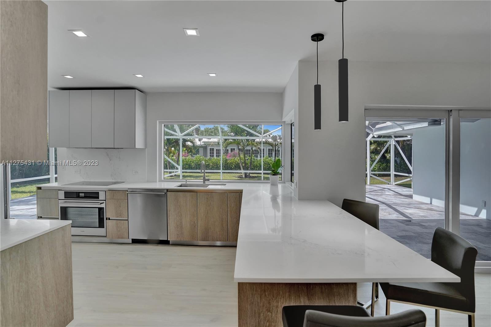 1311 Mulberry Way Boca Raton, FL 33486 - Photo 3 of 45 a kitchen with a table chairs sink and cabinets