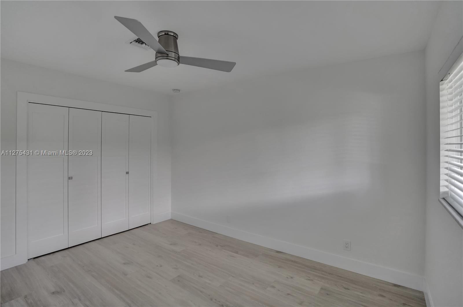 1311 Mulberry Way Boca Raton, FL 33486 - Photo 31 of 45 a view of a room with wooden floor and windows