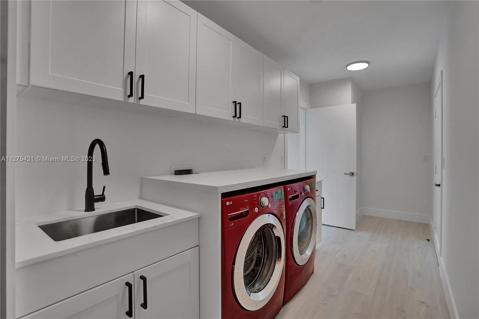1311 Mulberry Way Boca Raton, FL 33486 - Photo 33 of 45 a utility room with dryer and washer
