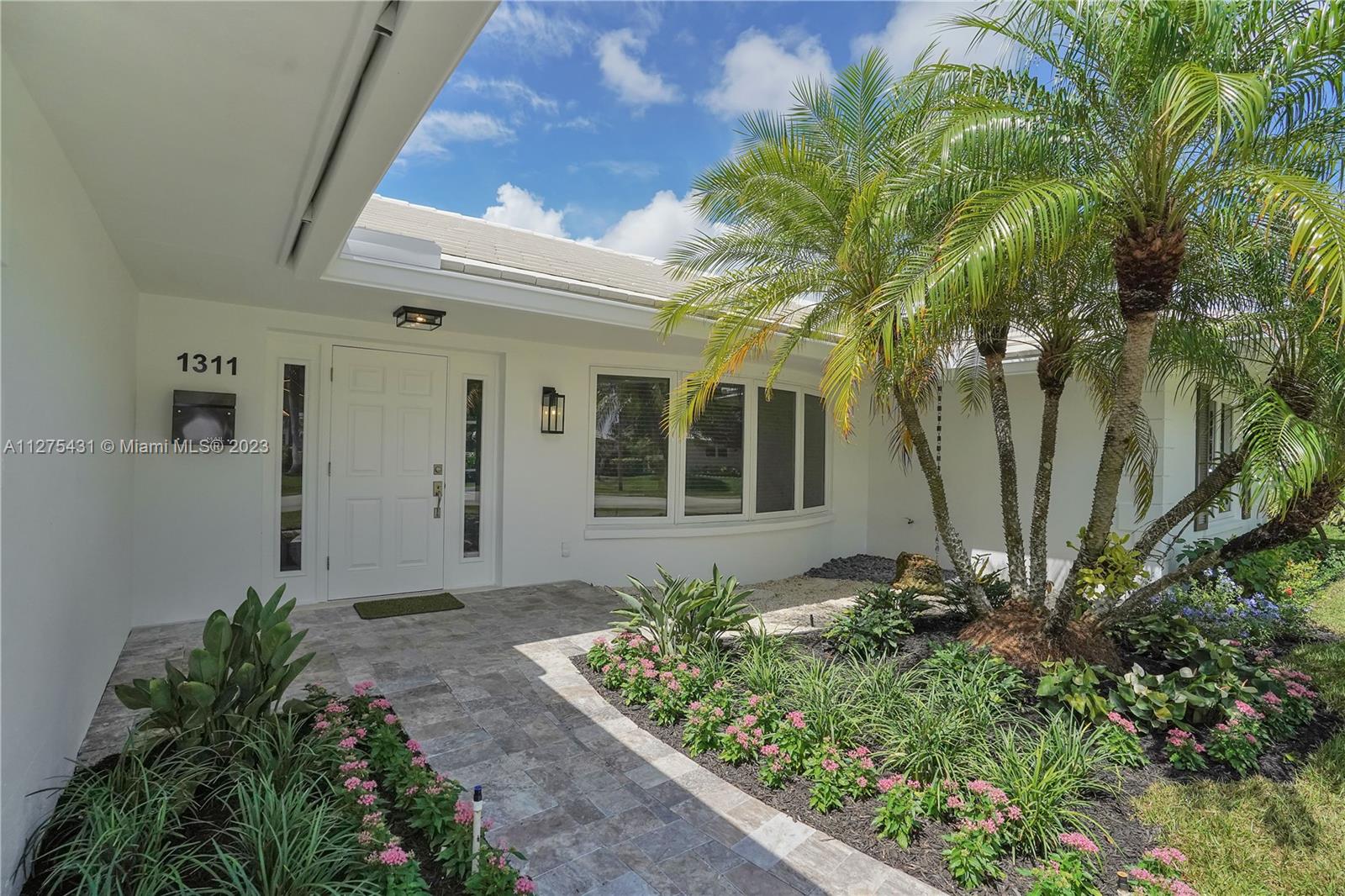 1311 Mulberry Way Boca Raton, FL 33486 - Photo 36 of 45 a front view of a house with a yard