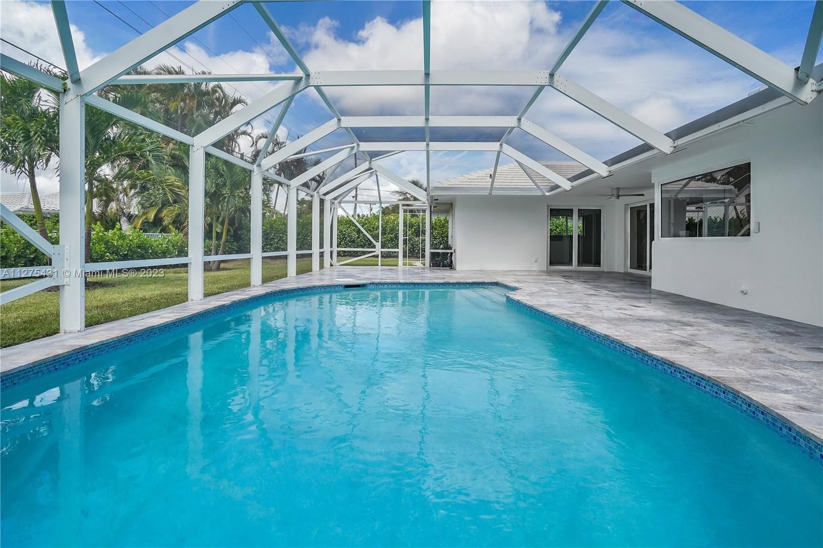 1311 Mulberry Way Boca Raton, FL 33486 - Photo 41 of 45 a view of a room with a large window and wooden fence