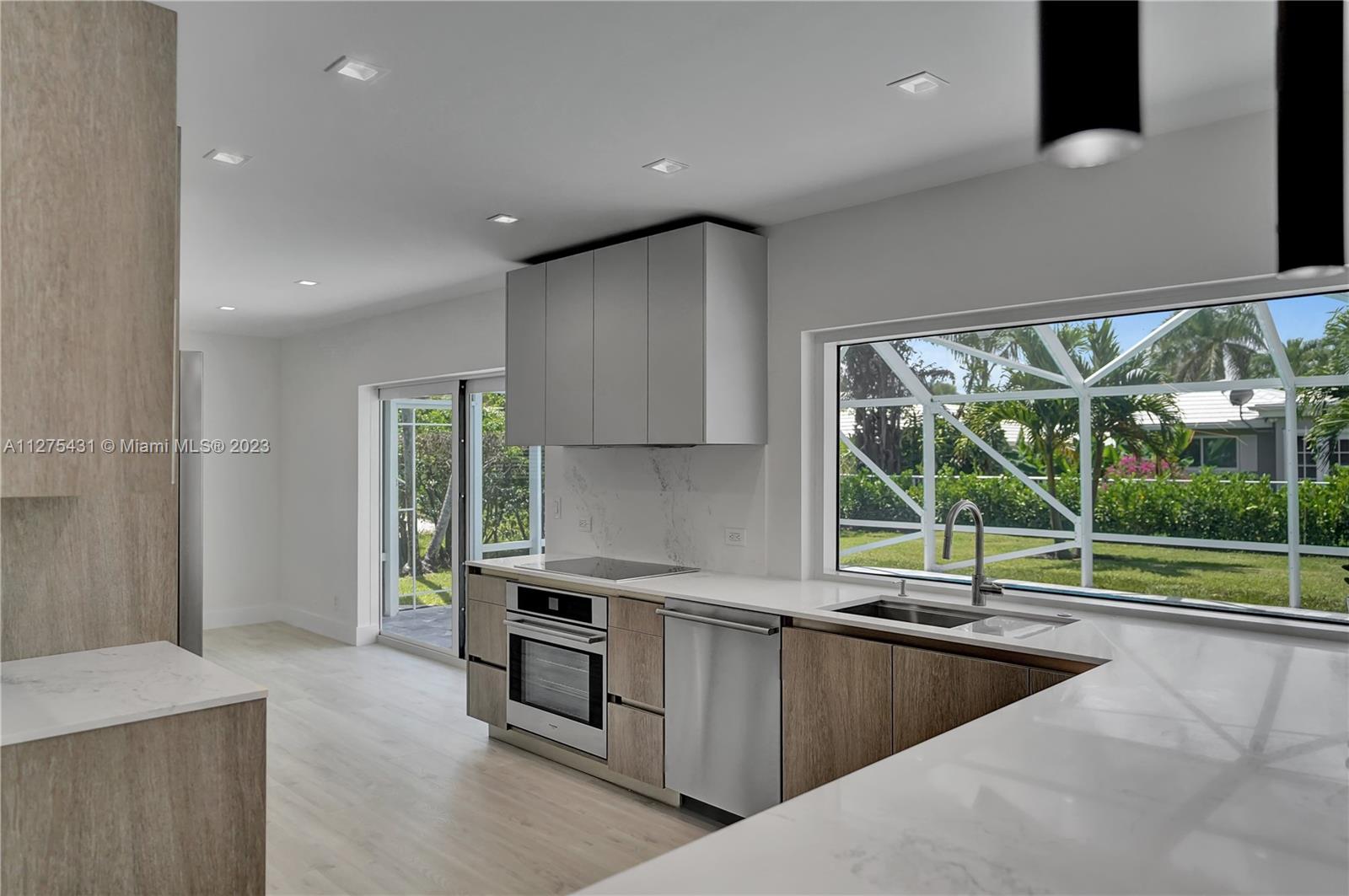 1311 Mulberry Way Boca Raton, FL 33486 - Photo 7 of 45 a kitchen with stainless steel appliances granite countertop a sink and a stove