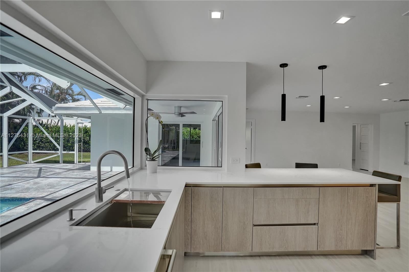 1311 Mulberry Way Boca Raton, FL 33486 - Photo 10 of 45 a kitchen with a sink and a large window