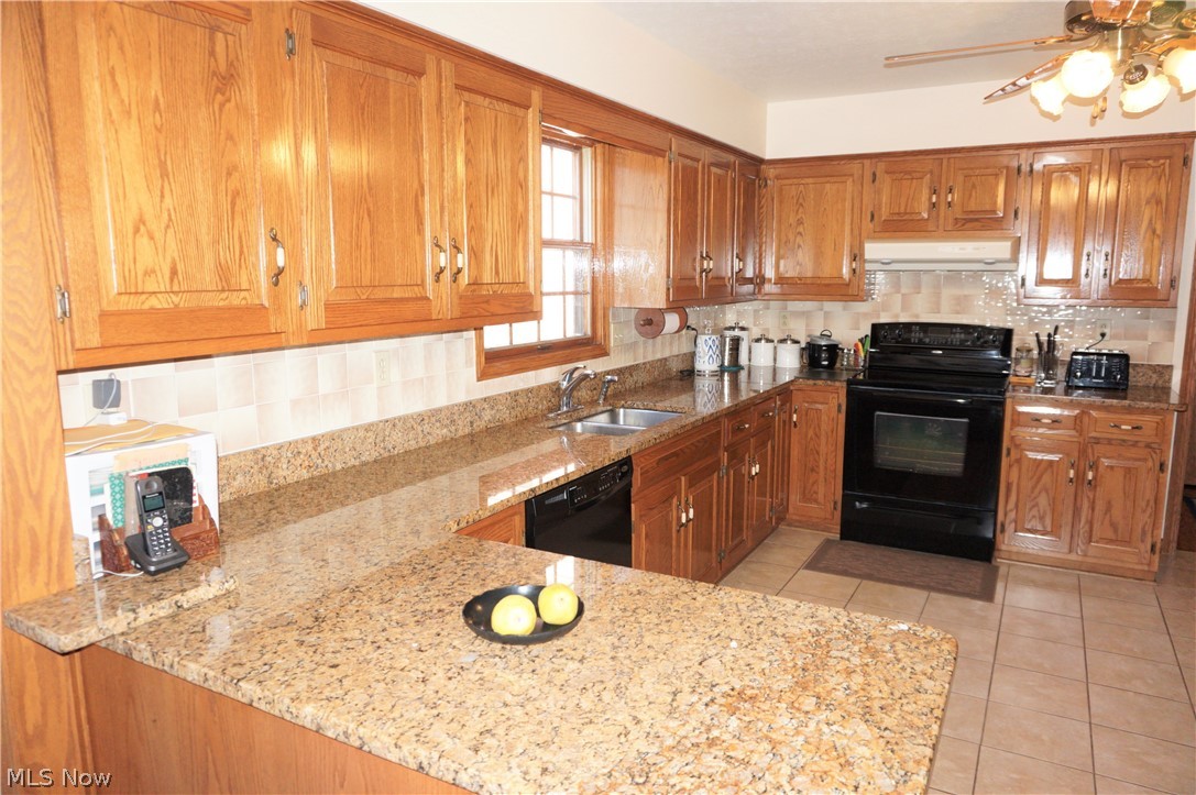 2577 Sourek Road Akron, OH 44333 - Photo 9 of 35 Gorgeous kitchen, Granite, porcelain floor. tile backsplash. Excellent condition. Each corner has a lazy Susan for easy access to items.