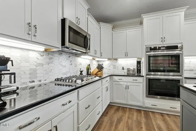 a room with a table chairs and wooden floor