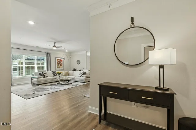 a living room with furniture fireplace and a large window