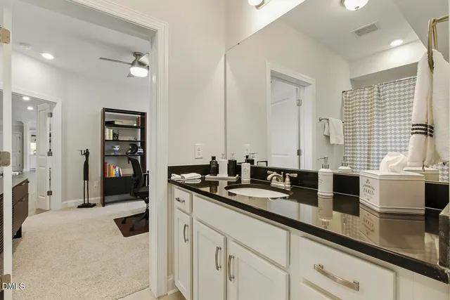 a living room with stainless steel appliances kitchen island granite countertop a dining table chairs and a oven