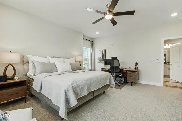 an aerial view of residential houses with outdoor space and trees