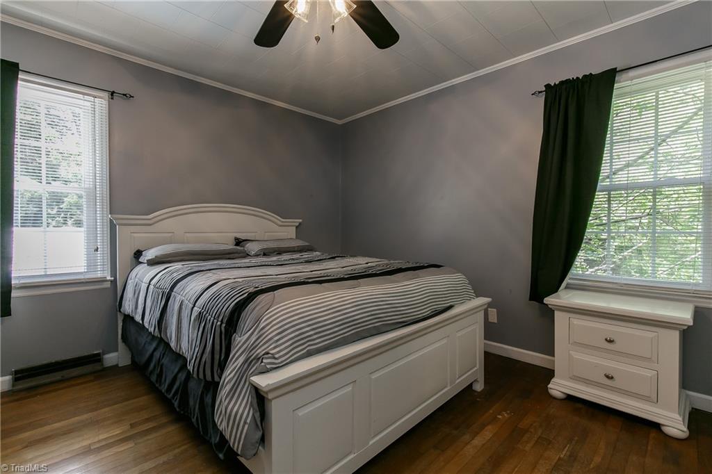 1336 A Townbranch Road Graham, NC 27253 - Photo 23 of 36 Bedroom 2 with ceiling fan, gleaming hardwood floors, and two bright windows