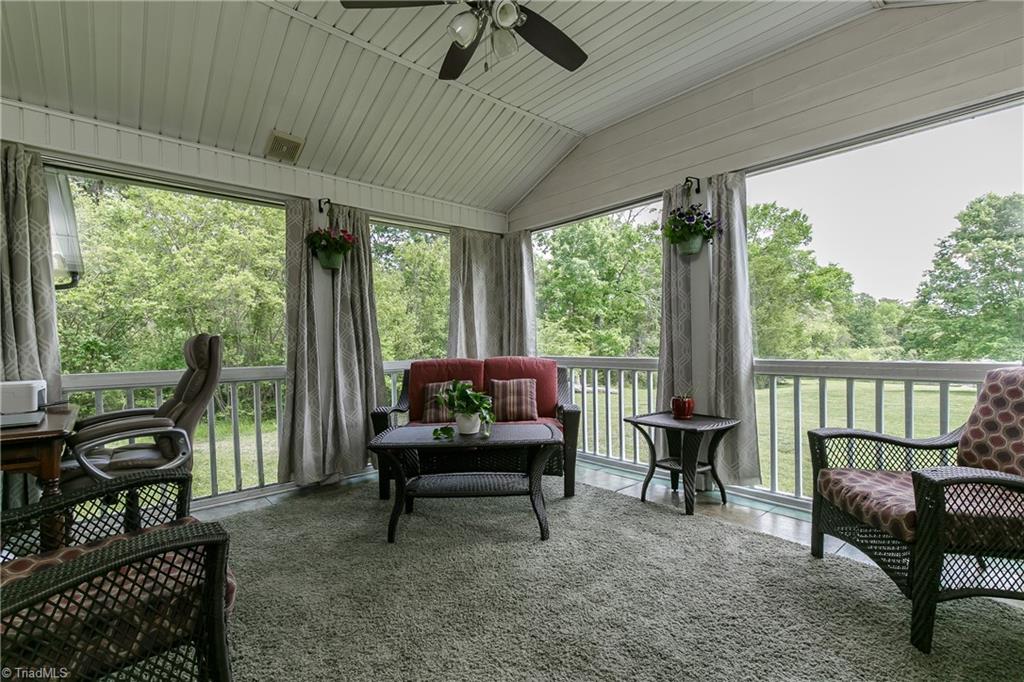 1336 A Townbranch Road Graham, NC 27253 - Photo 9 of 36 Bright sunroom overlooks the rolling green lot down to the glimmering spring fed pond
