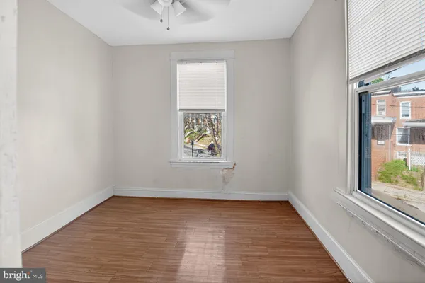 wooden floor in an empty room with a window