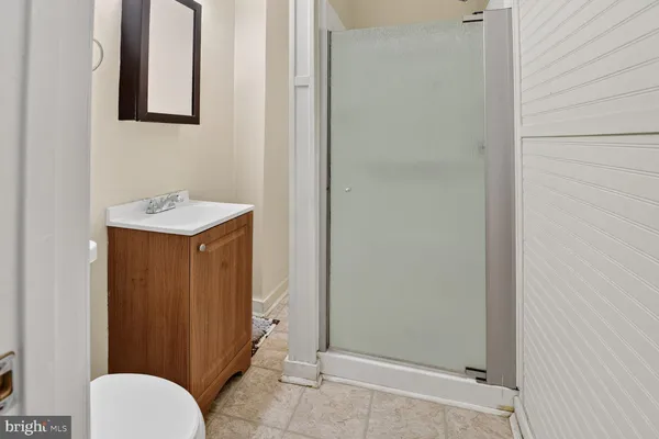 a bathroom with a sink toilet and mirror