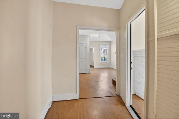 a view of a hallway with wooden floor