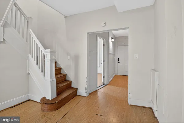 a view of entryway with stairs and wooden floor