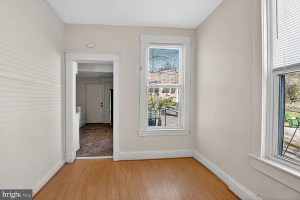 an empty room with windows and entrance