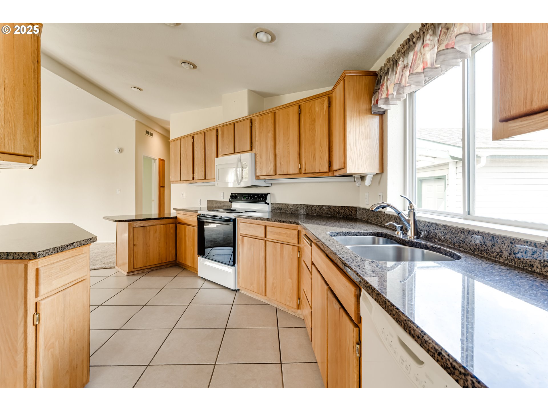 5353 Club Drive Eugene, OR 97402 - Photo 7 of 34 a kitchen with stainless steel appliances granite countertop a stove a sink and a refrigerator