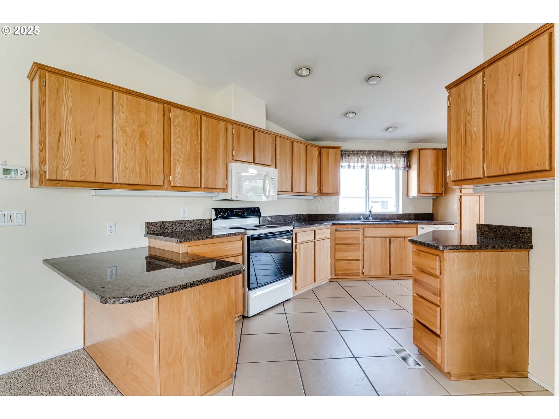 5353 Club Drive Eugene, OR 97402 - Photo 8 of 34 a kitchen with stainless steel appliances granite countertop a stove a sink dishwasher and a refrigerator