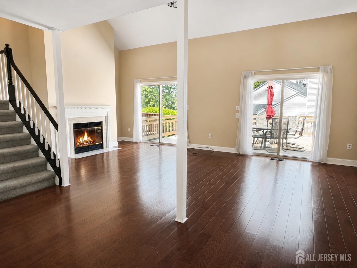 91 Delaware Lane Somerville, NJ 08876 - Photo 11 of 33 a view of an empty room with wooden floor fireplace and a window