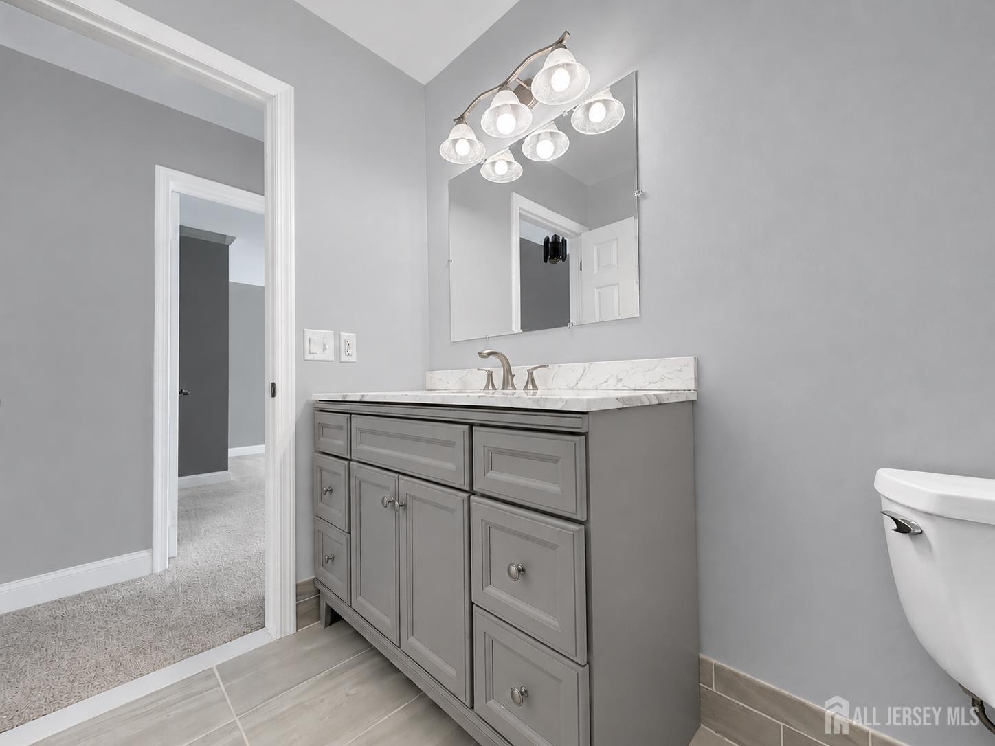 91 Delaware Lane Somerville, NJ 08876 - Photo 17 of 33 a bathroom with a sink a toilet and a mirror