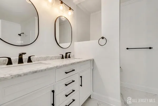 a bathroom with a double vanity sink and a mirror