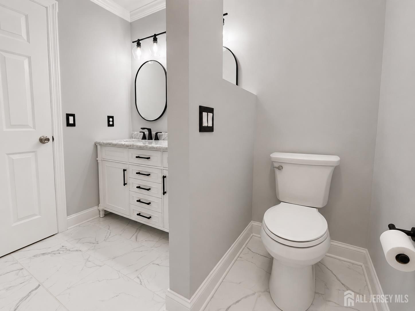 91 Delaware Lane Somerville, NJ 08876 - Photo 24 of 33 a bathroom with a toilet sink vanity and mirror