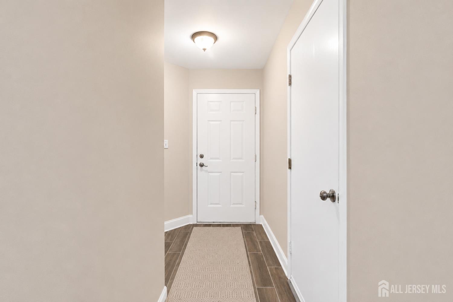 91 Delaware Lane Somerville, NJ 08876 - Photo 3 of 33 a view of a hallway with wooden floor