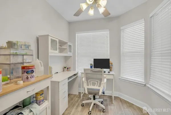 a view of a workspace with furniture and a window