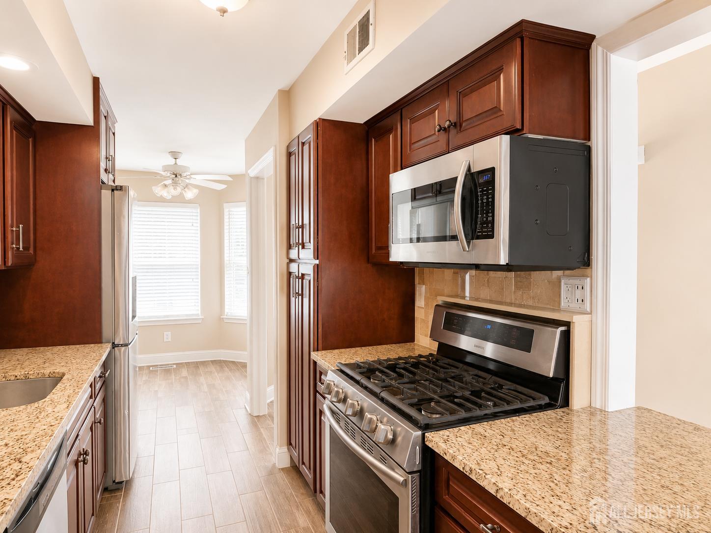 91 Delaware Lane Somerville, NJ 08876 - Photo 6 of 33 a kitchen with stainless steel appliances granite countertop a stove a refrigerator and a microwave