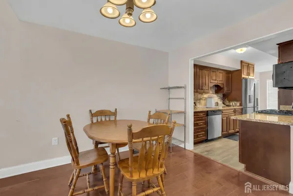 a dining room with furniture and kitchen view
