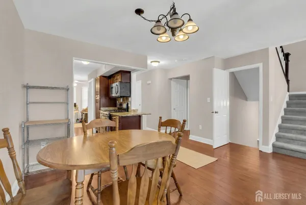a view of a dining room with furniture wooden floor and a chandelier