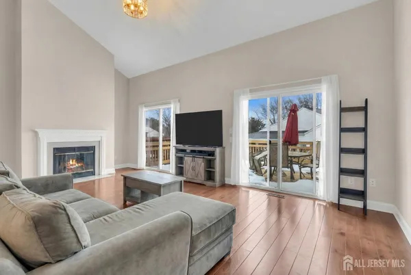 a living room with furniture a flat screen tv and a fireplace