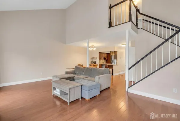 a living room with furniture and stairs