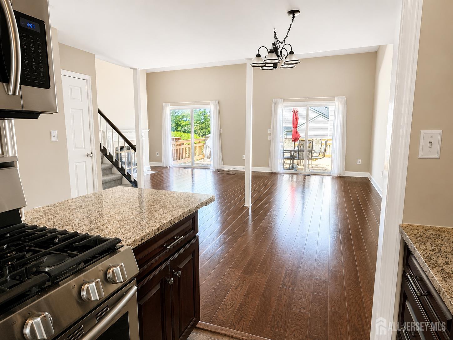 91 Delaware Lane Somerville, NJ 08876 - Photo 10 of 33 a kitchen with granite countertop a stove and a wooden floor