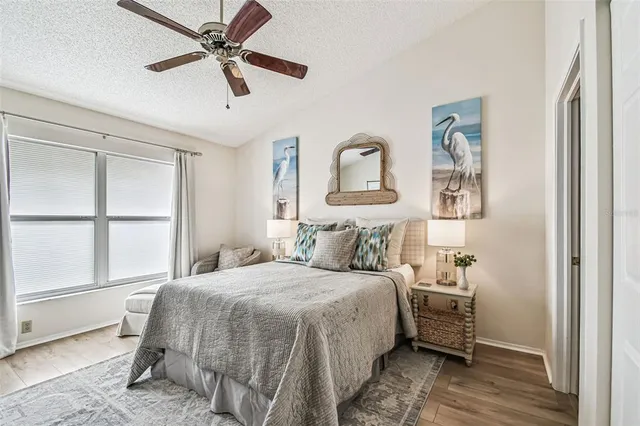 a bedroom with a bed and a painting on the wall
