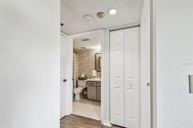 a bedroom with a bed chandelier and a window