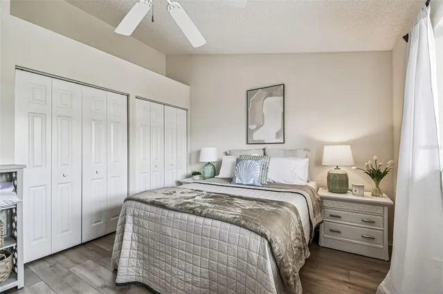 a bedroom with a bed and a large window