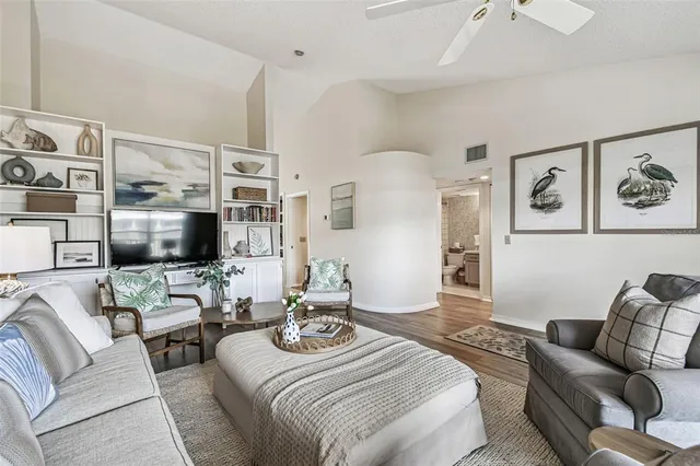 a living room with furniture flat screen tv and couches